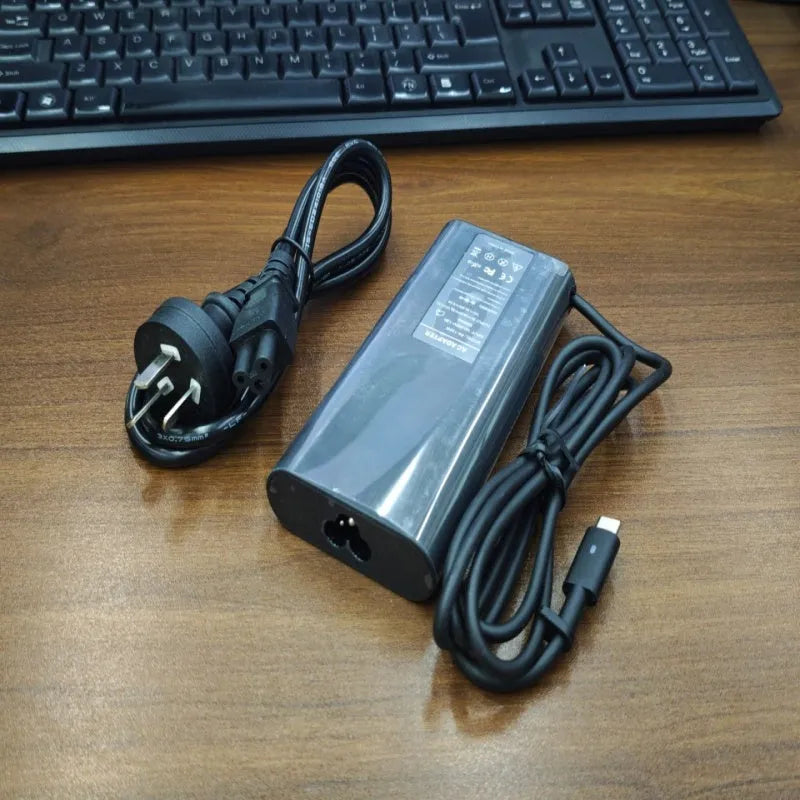 Black 65W laptop Type-C power adapter with multiple international plug cords