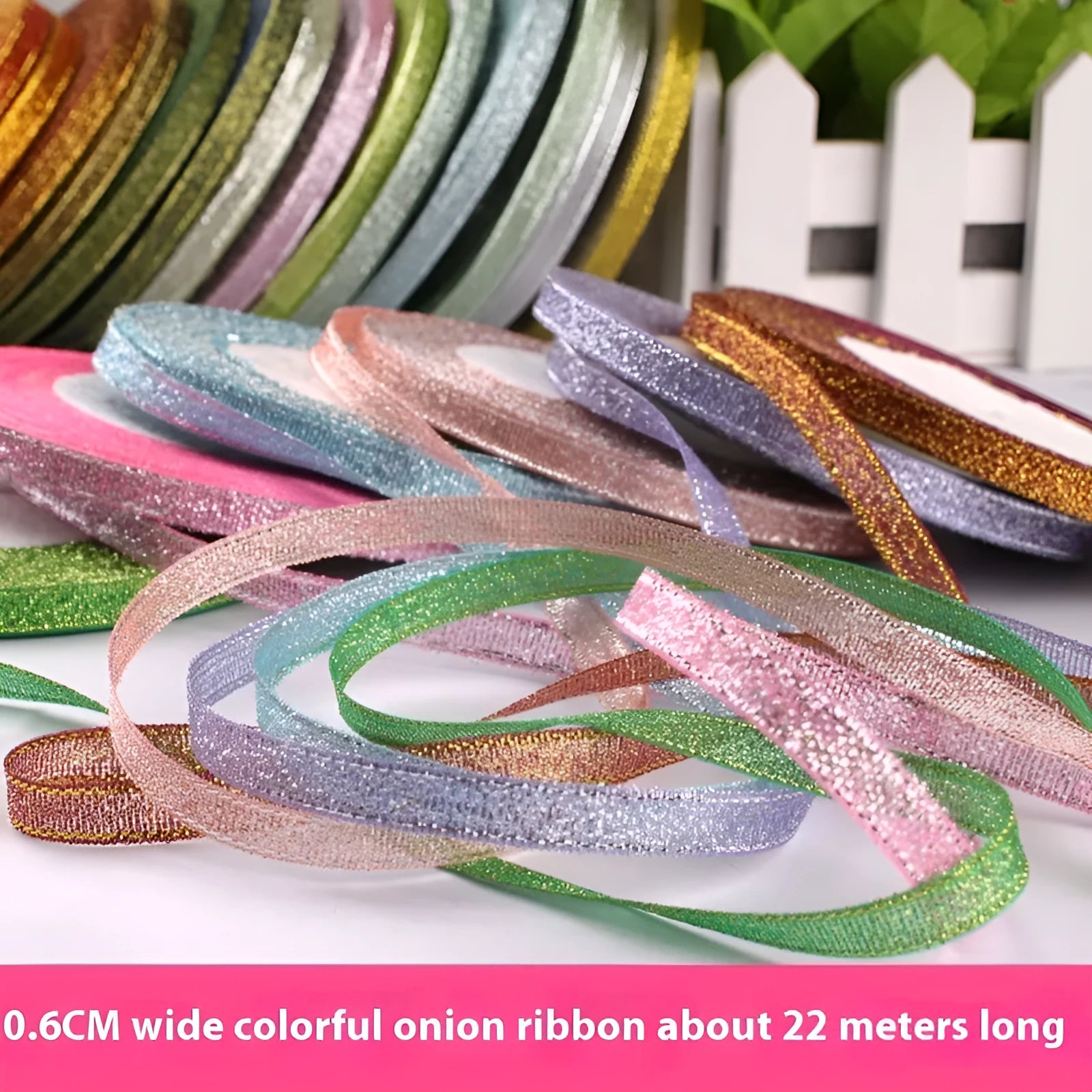 Roll of narrow 0.6cm wide polyester gift ribbon in a multicolour pattern.