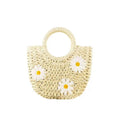 Light brown straw-weaved women's crossbody bag with daisy pattern, showing woven texture and crossbody strap