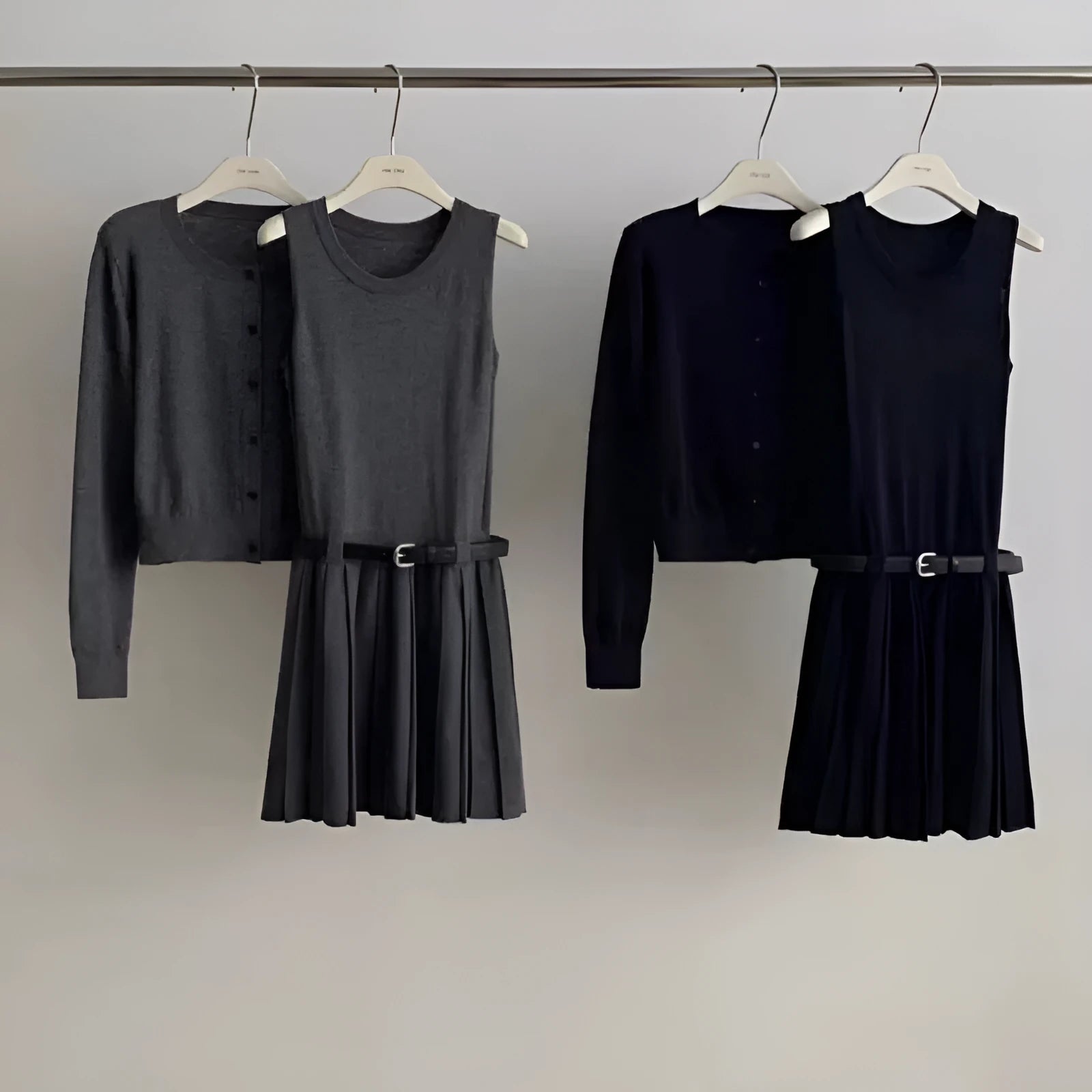 Grey art retro knitted two-piece set with 3D pattern, featuring a pleated vest skirt with belt and a V-neck long-sleeve cardigan.