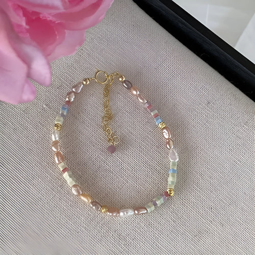 A women's bracelet and necklace set with irregular natural pearls and a 14K gilded purple finish.