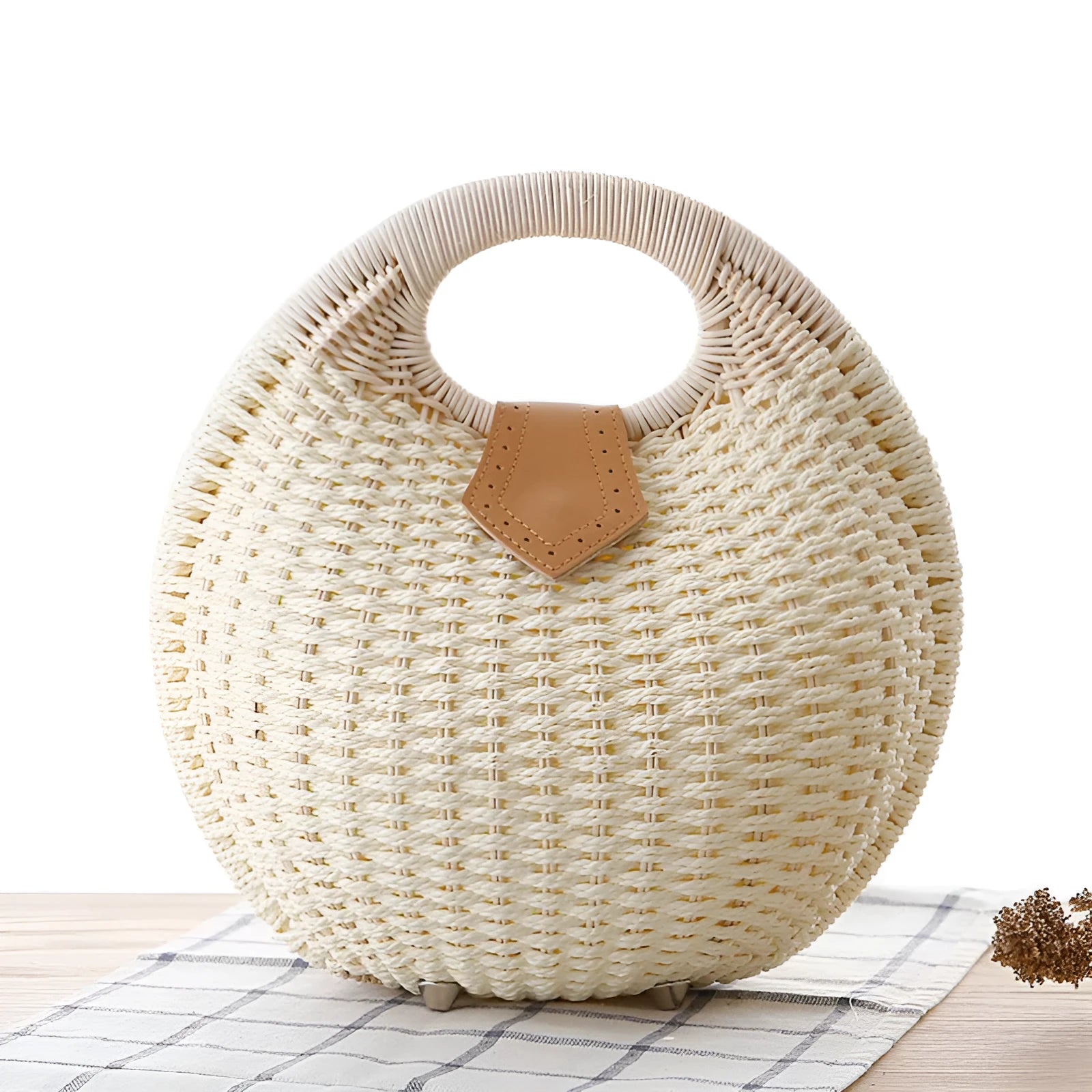 Women's round woven paper rope handbag in beige with hard shell, cover closure, and hard handle