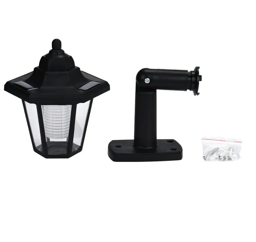 Black hexagonal solar-powered wall light with LED and solar panel for outdoor use