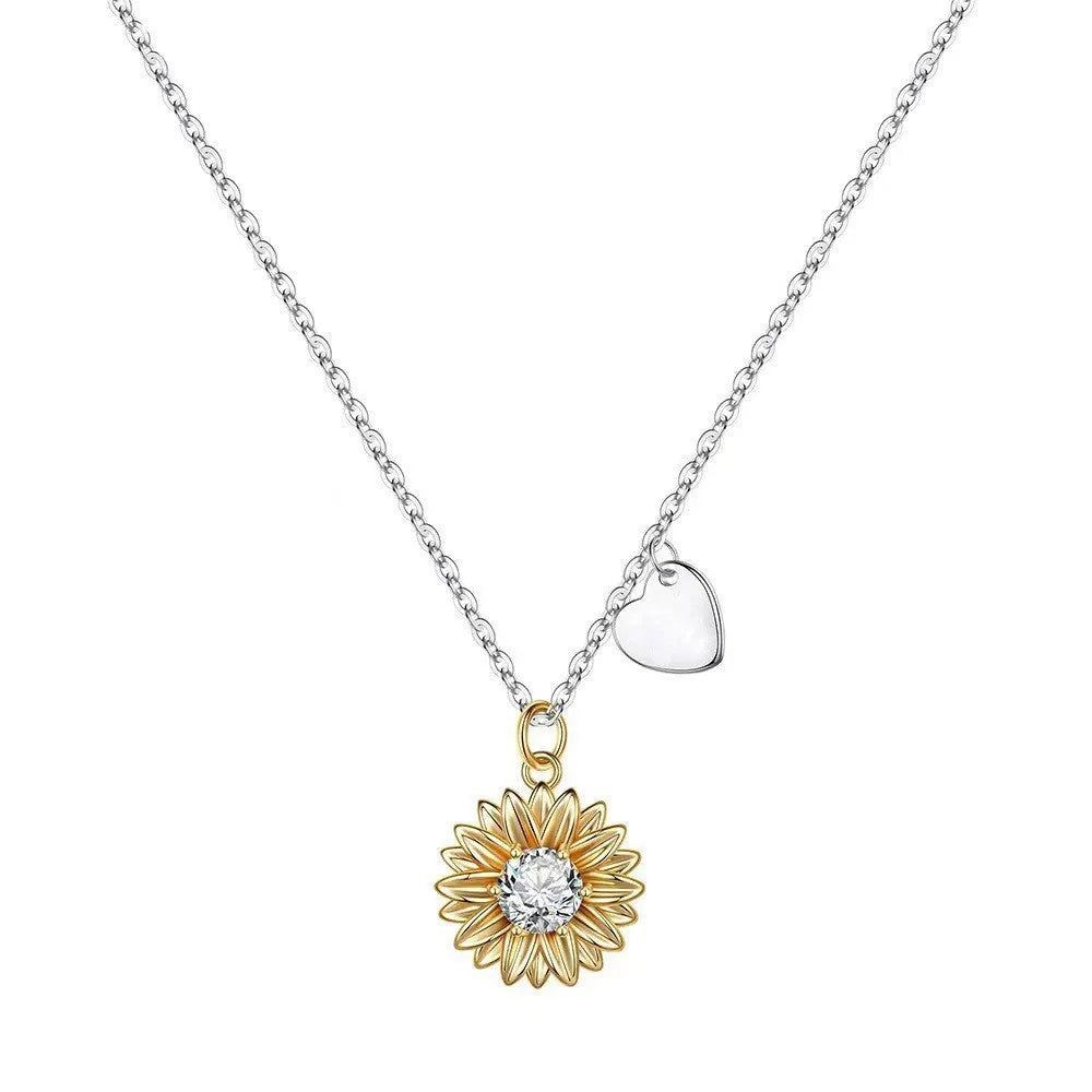 Close-up of a geometric sunflower pendant necklace on an adjustable silver cross chain.