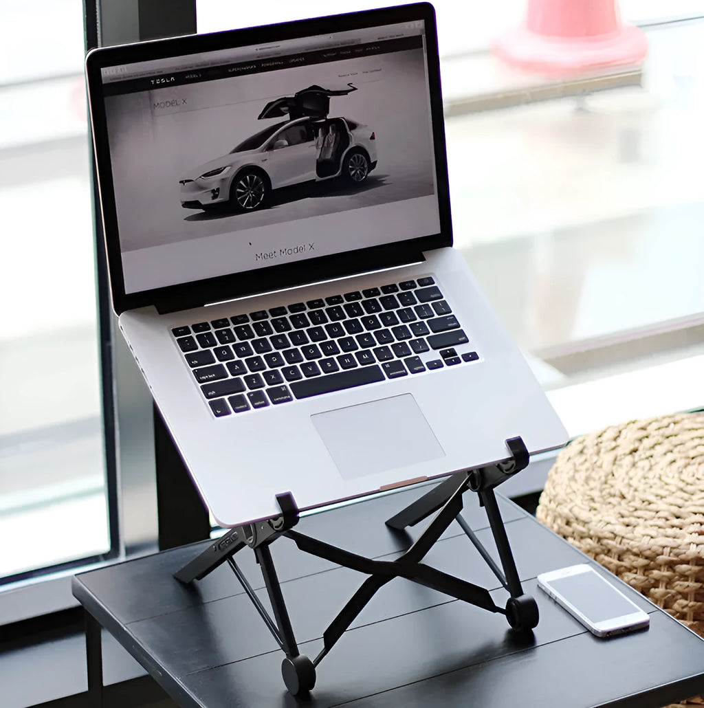 Black folding portable laptop stand made of reinforced nylon, shown open and folded to 4cm depth.