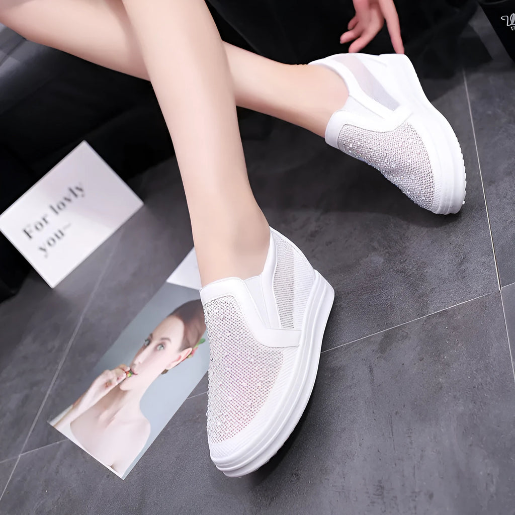 Women's wedge slip-on shoes with mesh upper in black colour showing rubber sole