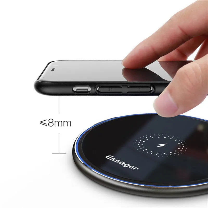 Black aluminium alloy 15W Qi fast wireless charging pad on a wooden desk