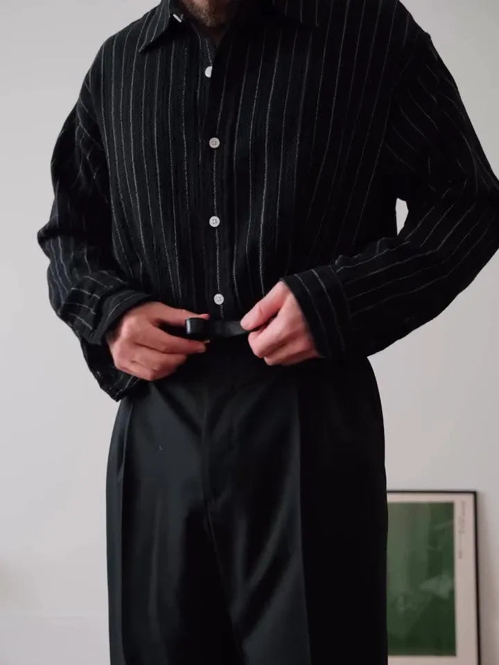 Black pinstriped button-down polyester shirt on a hanger, showing regular fit and striped pattern.