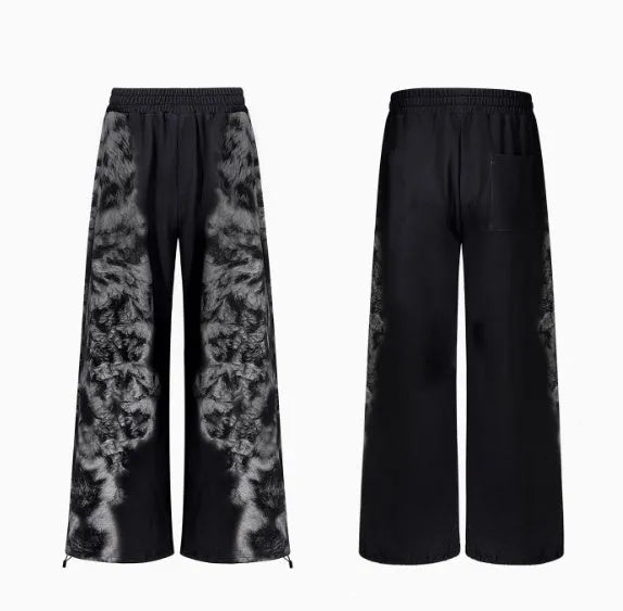 Unisex grey streetwear co-ord set featuring a printed hoodie, loose trousers, and seven-inch shorts laid flat