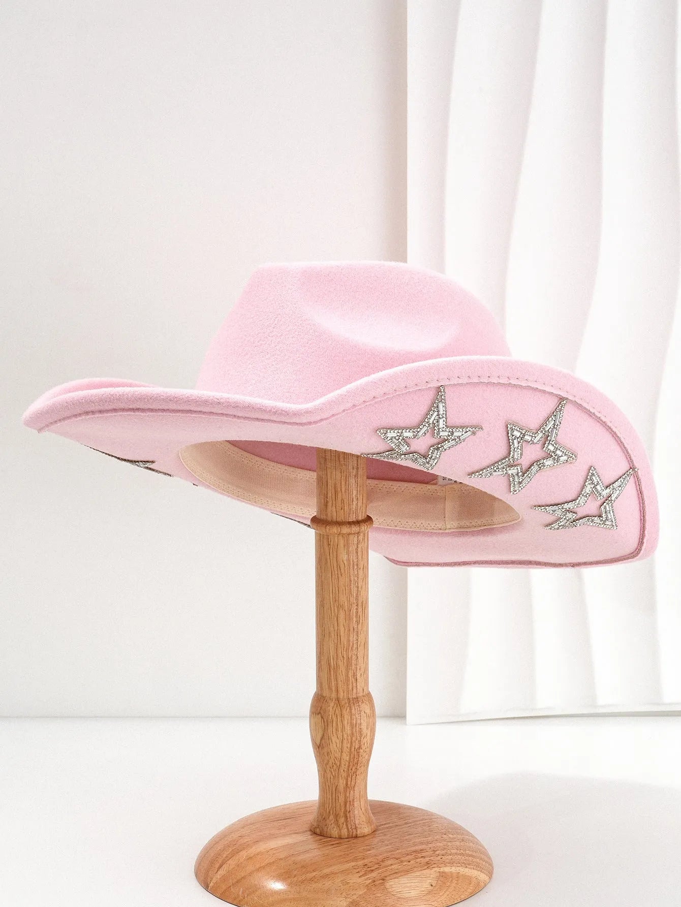Beige woven polyester western top hat with a conical crown and a hexagonal star decoration on the front.