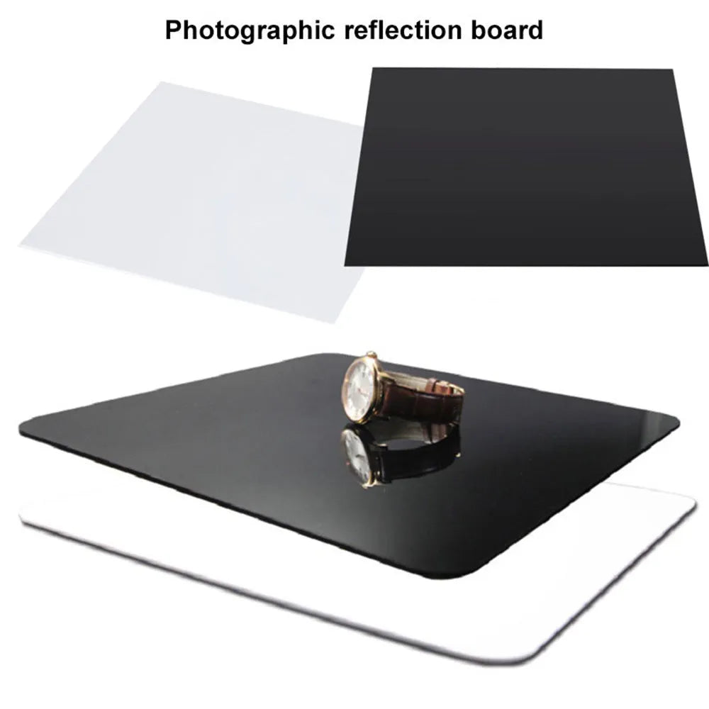 Square black and white acrylic shooting reflection boards for photography in three sizes on a table.