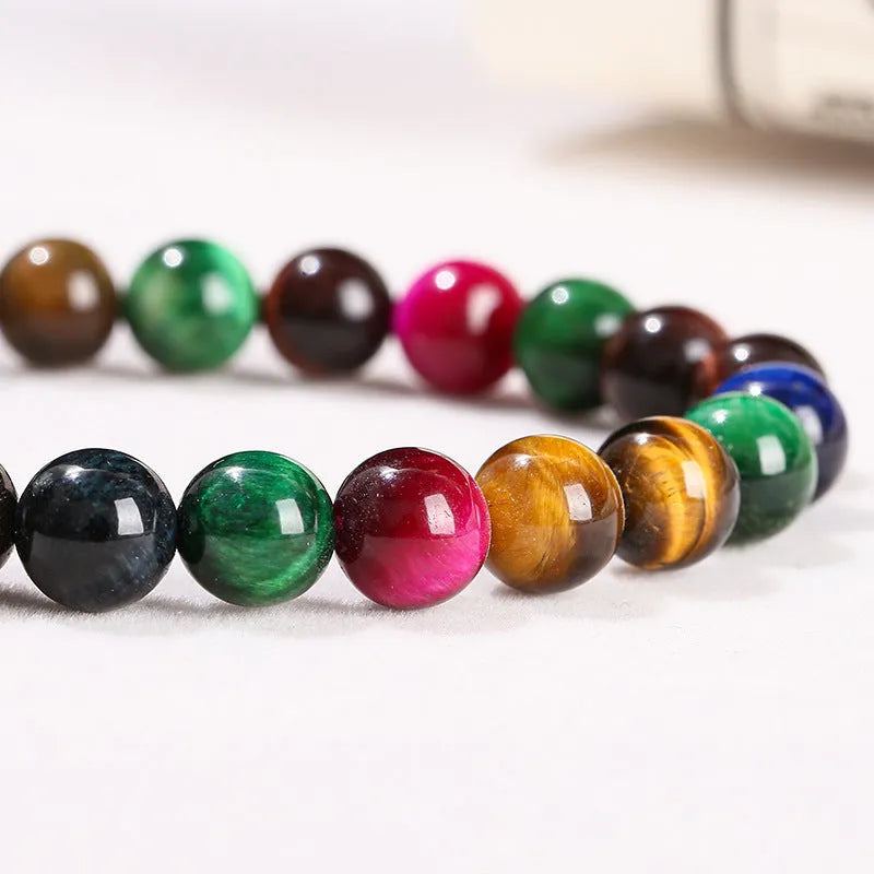 Colourful tiger's eye natural stone bracelet with round beads on a string lace, shown in unisex design.