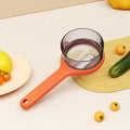 Kitchen storage peeler with integrated bucket in light green or orange colour