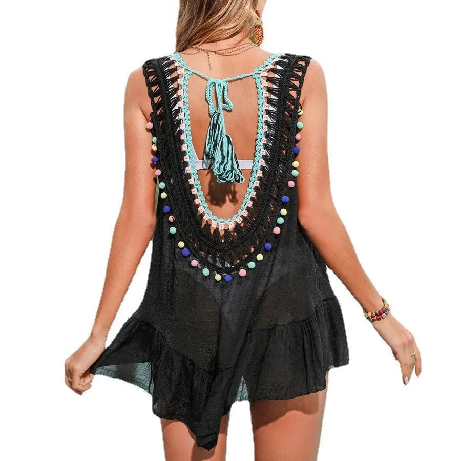 Black women's crochet beach cover-up vest with ruffled cut-out design.