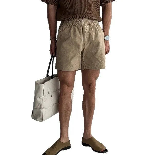 Cotton loose-fit sports shorts in black, shown on a model for summer athletic wear.
