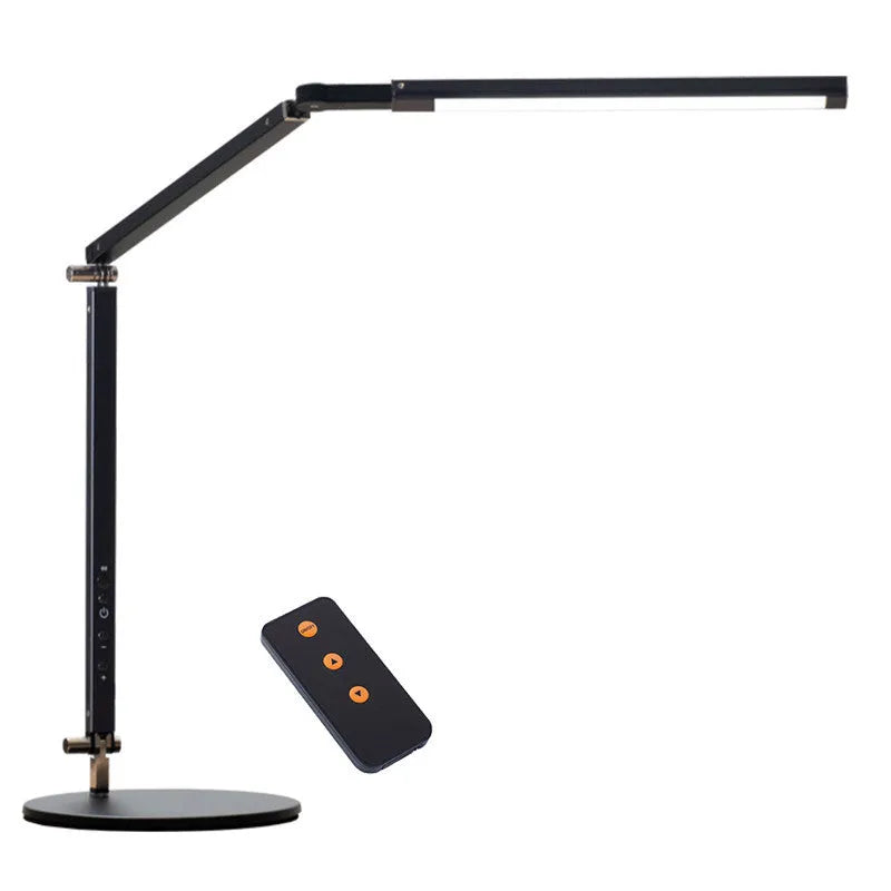 Adjustable LED desk lamp with clip attachment in black finish on wooden desk