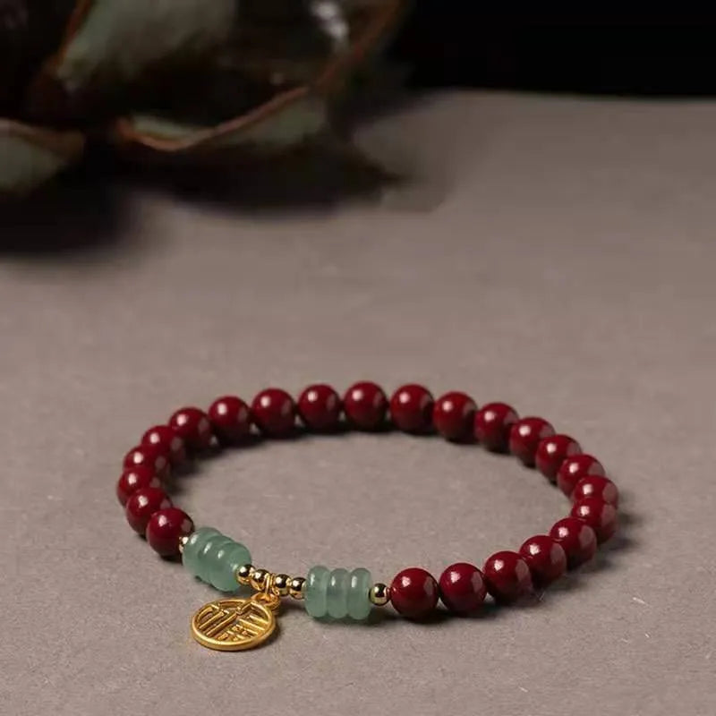 Handmade gold cinnabar wave bracelet showing genuine stone and copper bead construction in national style design