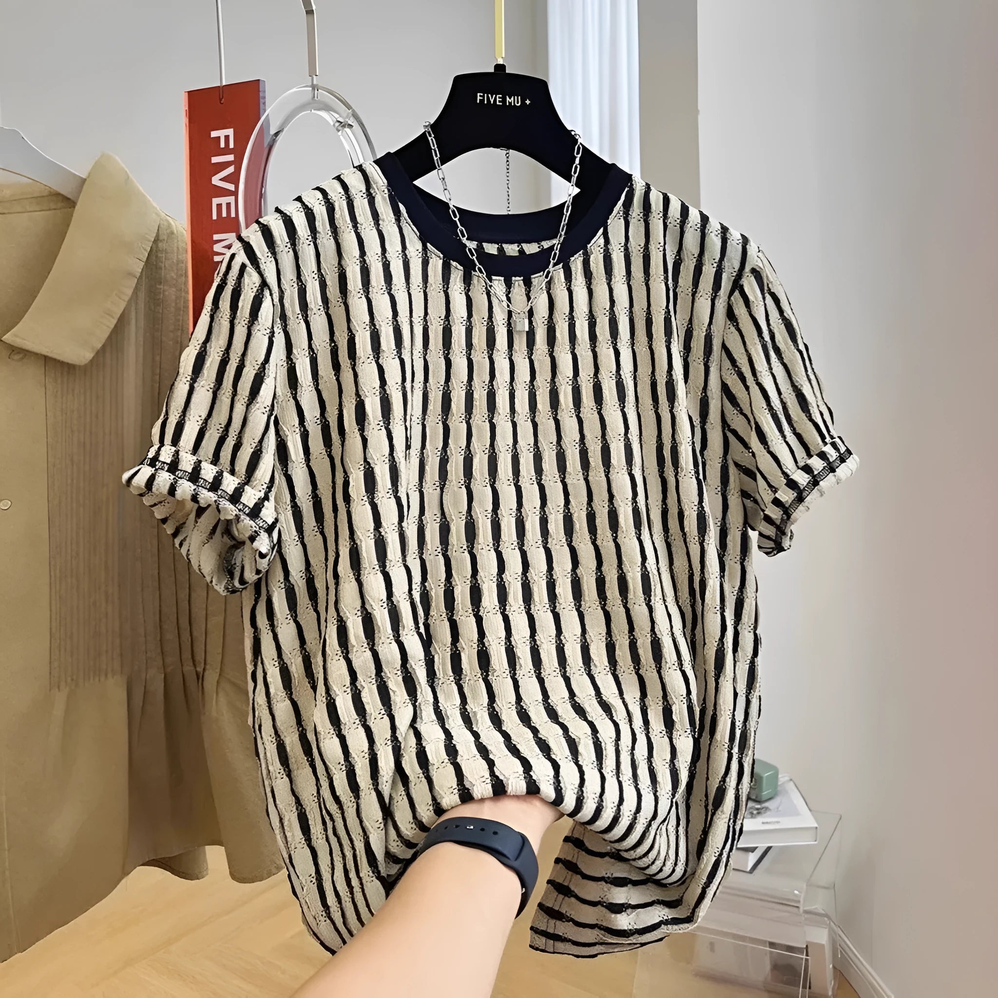 Men's black striped linen silk blend short sleeve shirt laid flat showing loose casual fit