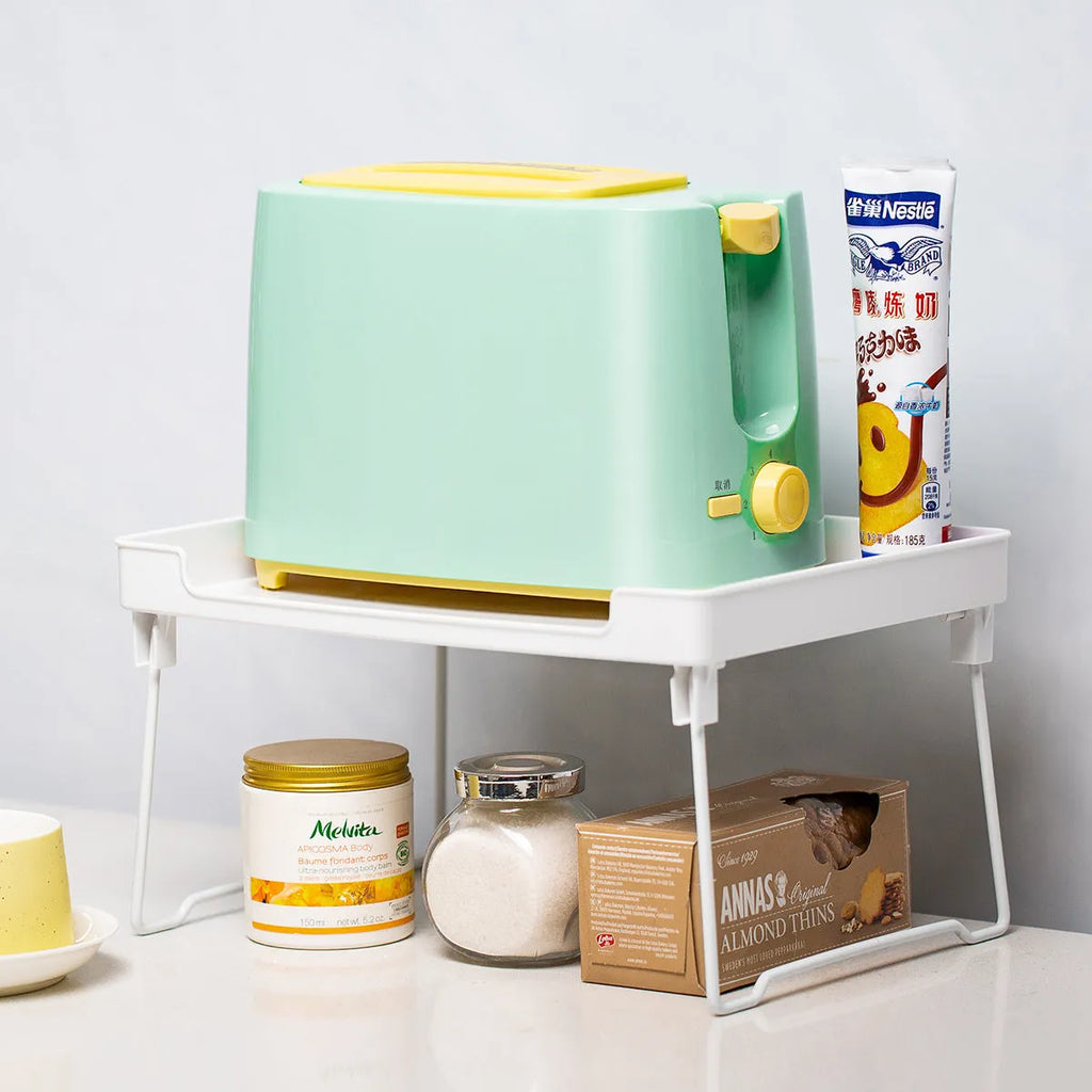 Transparent or white plastic kitchen supplies rack on a countertop or inside a cupboard