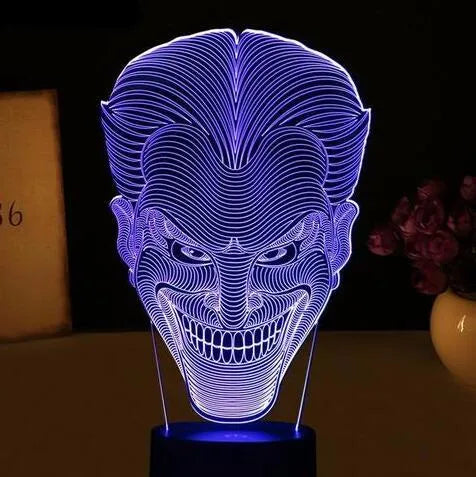 USB-powered 3D acrylic LED lamp displaying multiple colours on a desk with remote control.