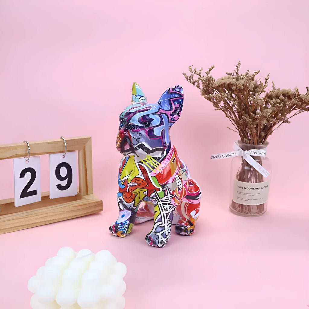 Graffiti coloured solid resin French bulldog statue on a wooden surface.