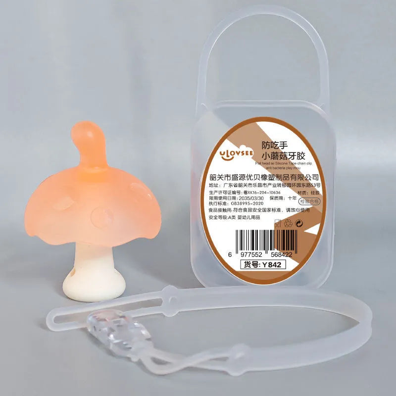Small pink silicone mushroom chew and transparent storage box on a white background.