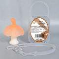 Small pink silicone mushroom chew and transparent storage box on a white background.
