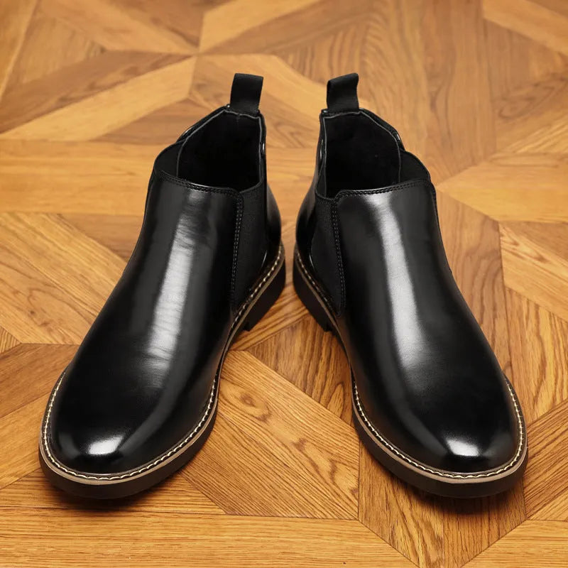 Black formal leather pointed-toe boots with a square heel and rubber sole on a white background.