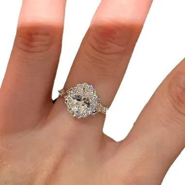 Silver geometric bridal bouquet ring with adjustable opening on finger.