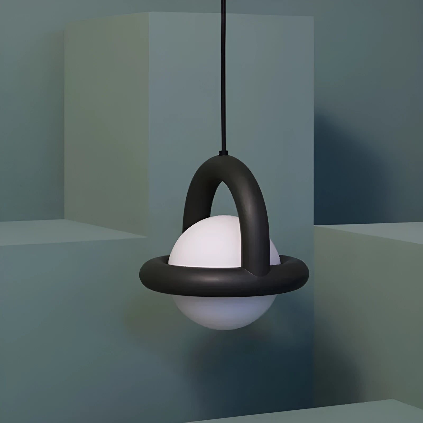 Matte black hanging line lamp with a long black cord suspended above a bedside table.