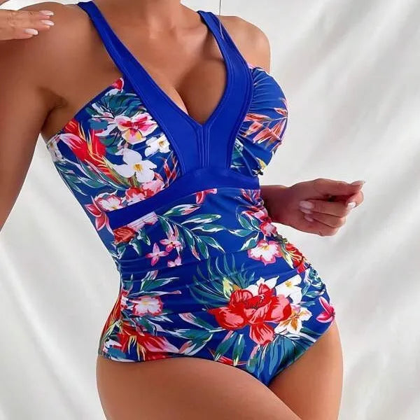 Women's floral pattern backless one-piece swimsuit on a hanger.