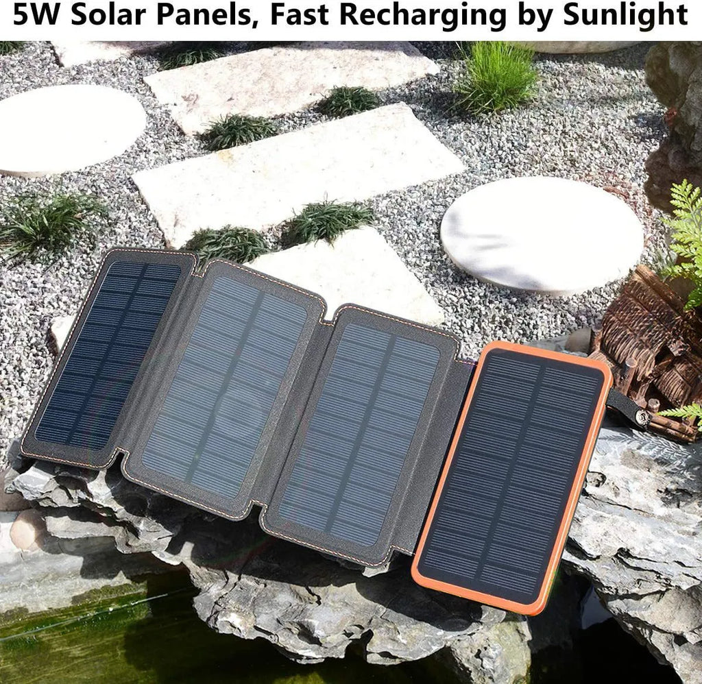 Outdoor solar power bank in black with a solar panel, soft leather finish, and LED light on a grassy field.