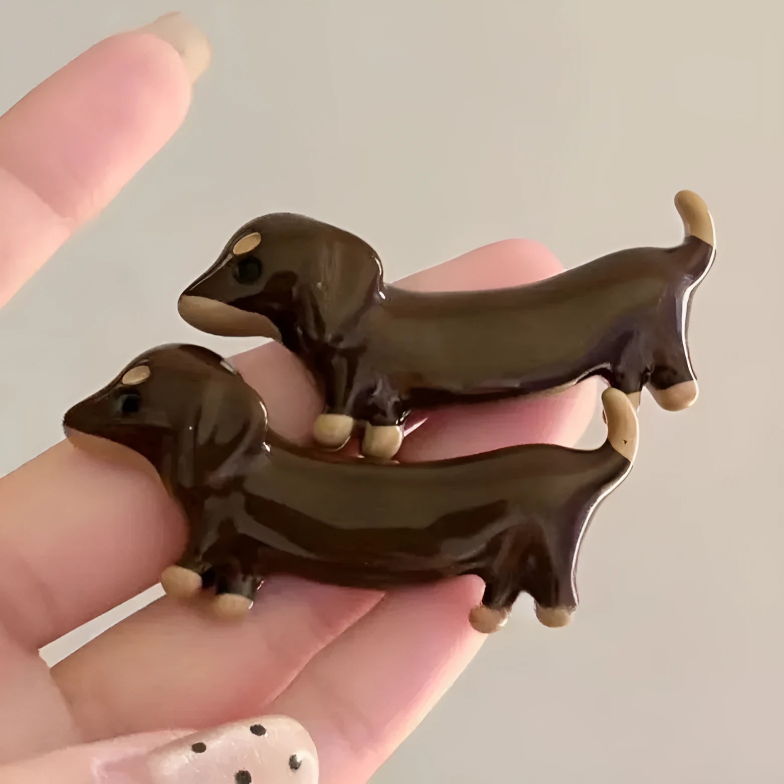 Dachshund dog shaped hair barrettes with electroplated finish, shown as a single clip or a pair.