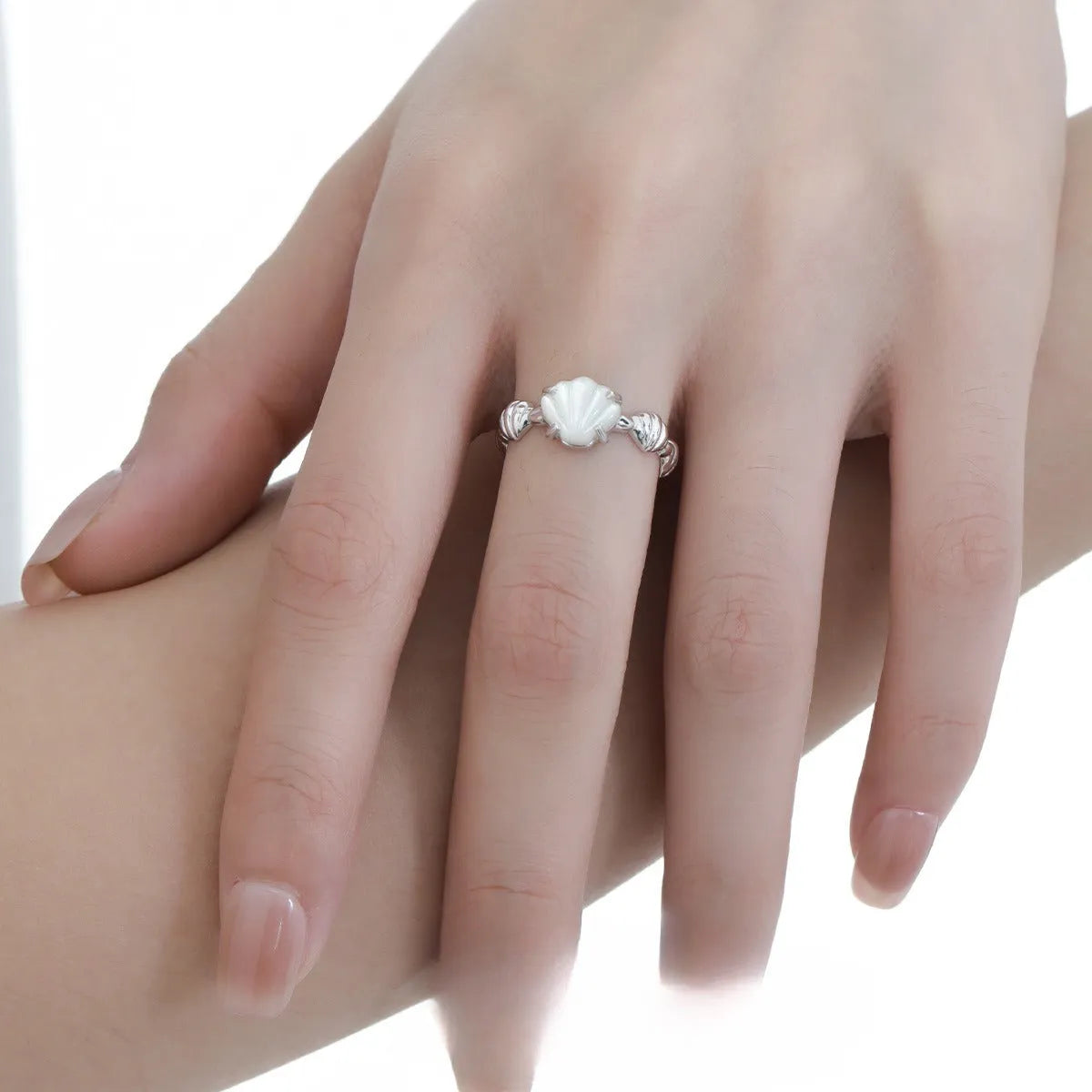 Adjustable silver ring with natural white shell and tiger eye detail, shown in white gold and 18K gold electroplated finishes.