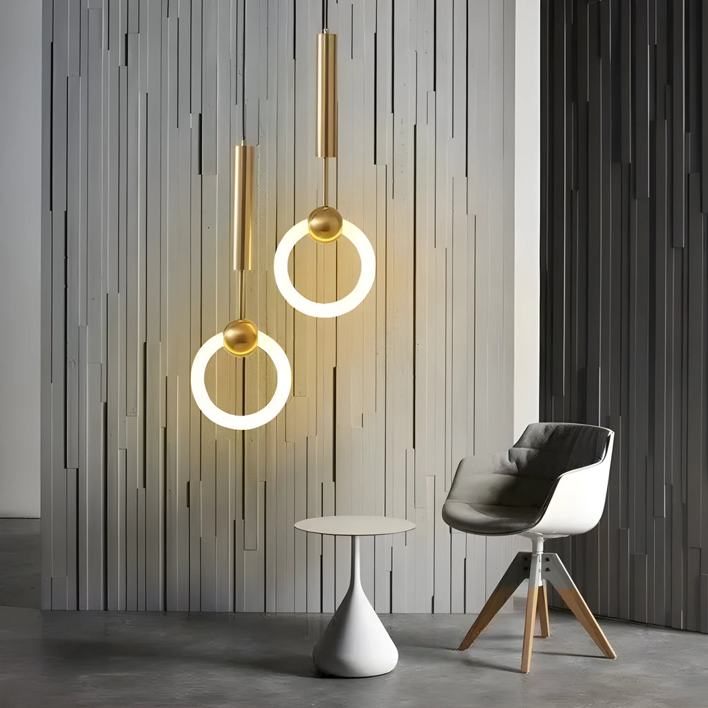 Modern Nordic-style U-shaped metal pendant light with a long black cable, hung above a bedside table.