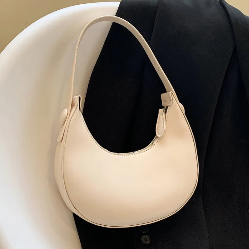 Women's retro brown dumpling-shaped PU leather shoulder bag showing front and internal zipper pocket.