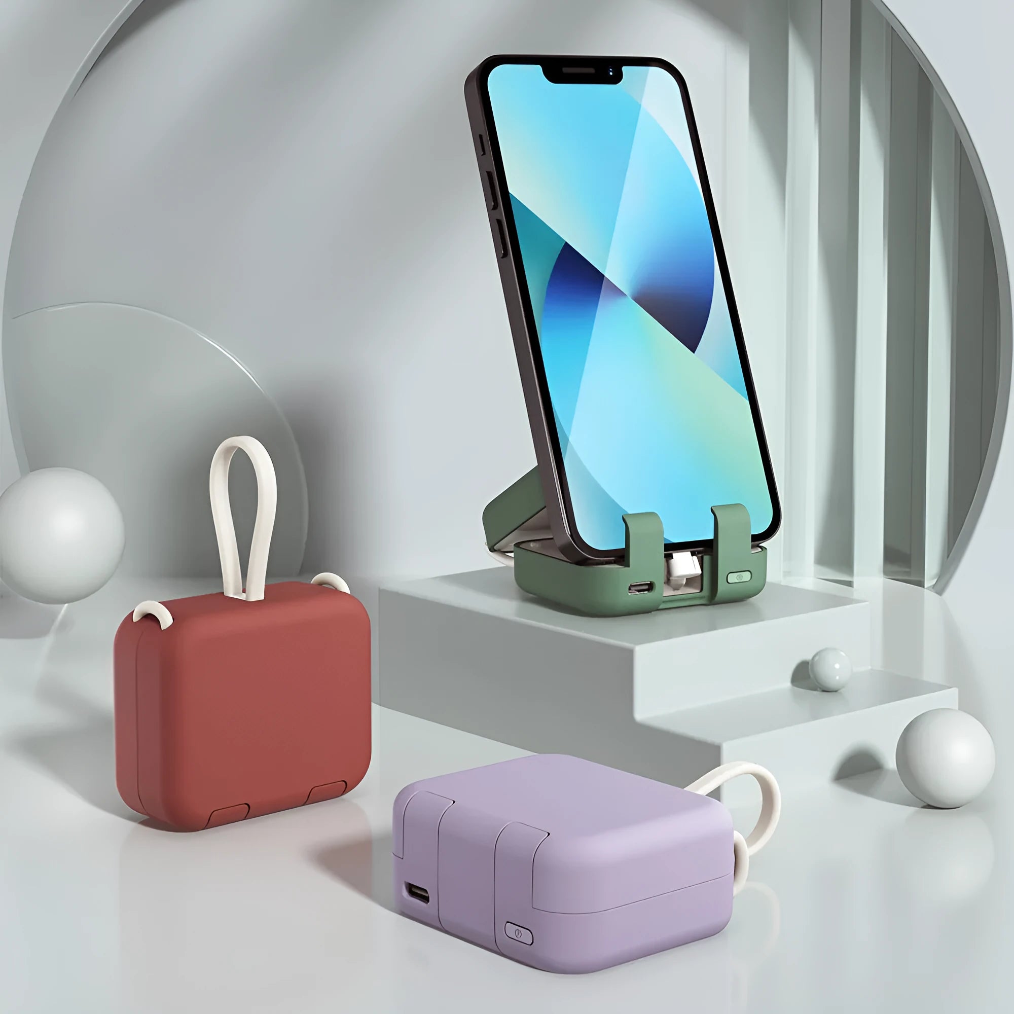 Multi-function bracket mobile power supply in red, green, or purple showing dual charging ports and integrated phone stand.