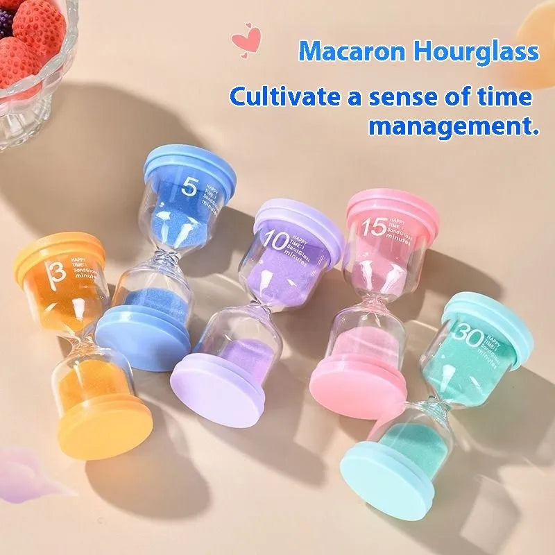 Handmade glass sand timer in blue colour showing sand flowing, on a wooden desk.
