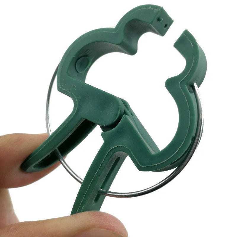 Green plastic and zinc plant fixing clips in large and small sizes for securing climbing plants.