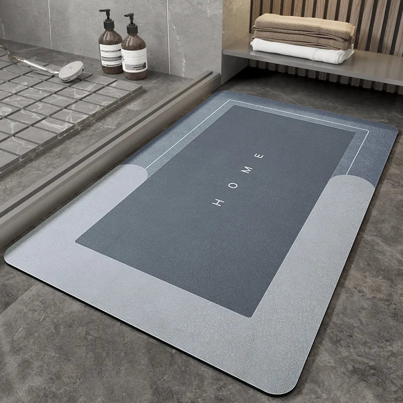 Machine-woven blended bathroom floor mat in blue, shown in an oval shape on a tiled floor.
