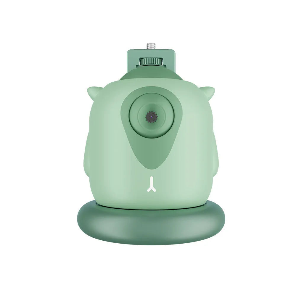 Dark green intelligent AI face tracking gimbal with 360-degree rotation on a table.