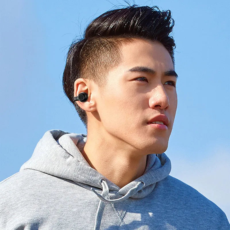 Black wireless Bluetooth clip-on bone conduction earphones for exercise with charging cable