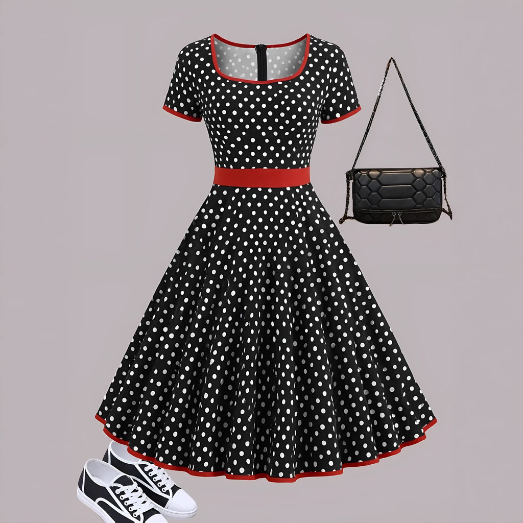 Multicolour polka dot dress with square collar, short sleeves, front zipper, and a pleated mid-length skirt on a hanger.
