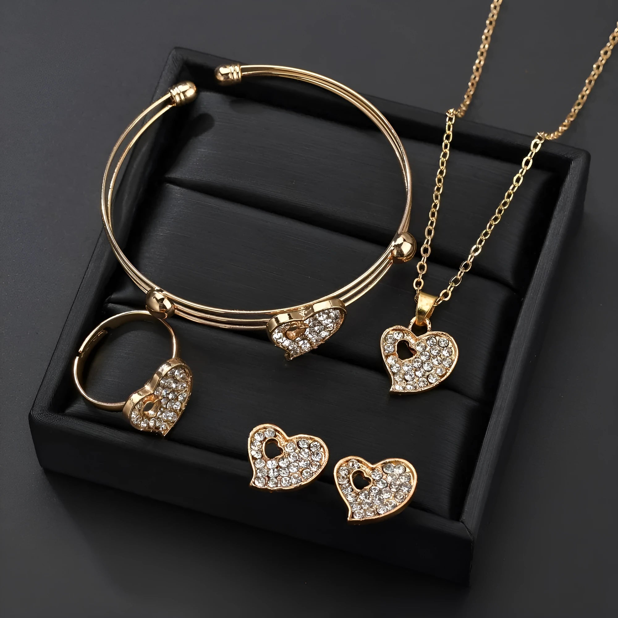 Women's gold electroplated jewellery set with earrings, pendant, and hand decoration featuring love, water drop, and bell patterns