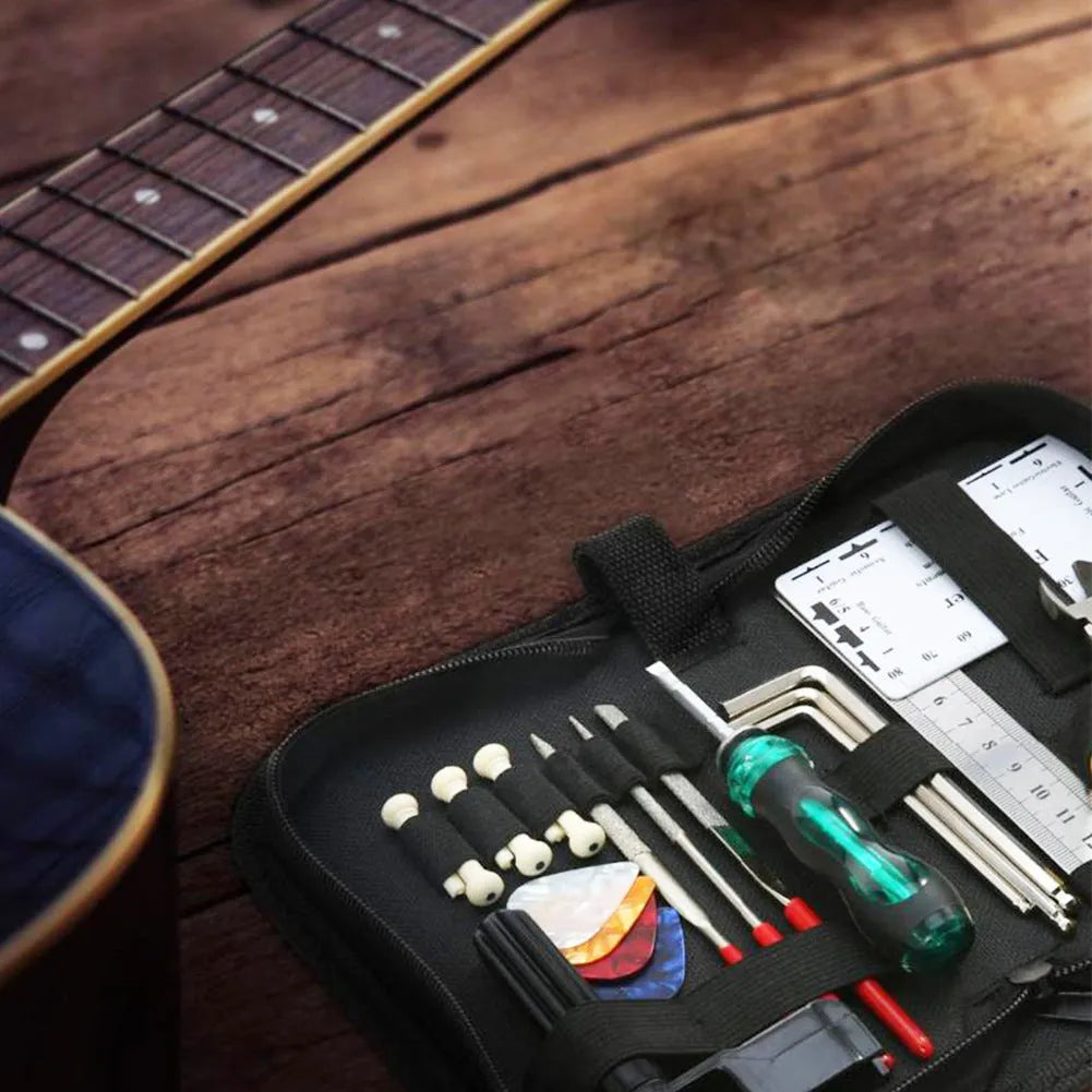 Black plastic case open to reveal 24 hardened steel guitar repair tools including cutters, winders, and files