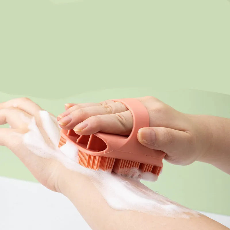 Blue silicone scalp massager brush with hand-strap handle for washing and massaging hair.