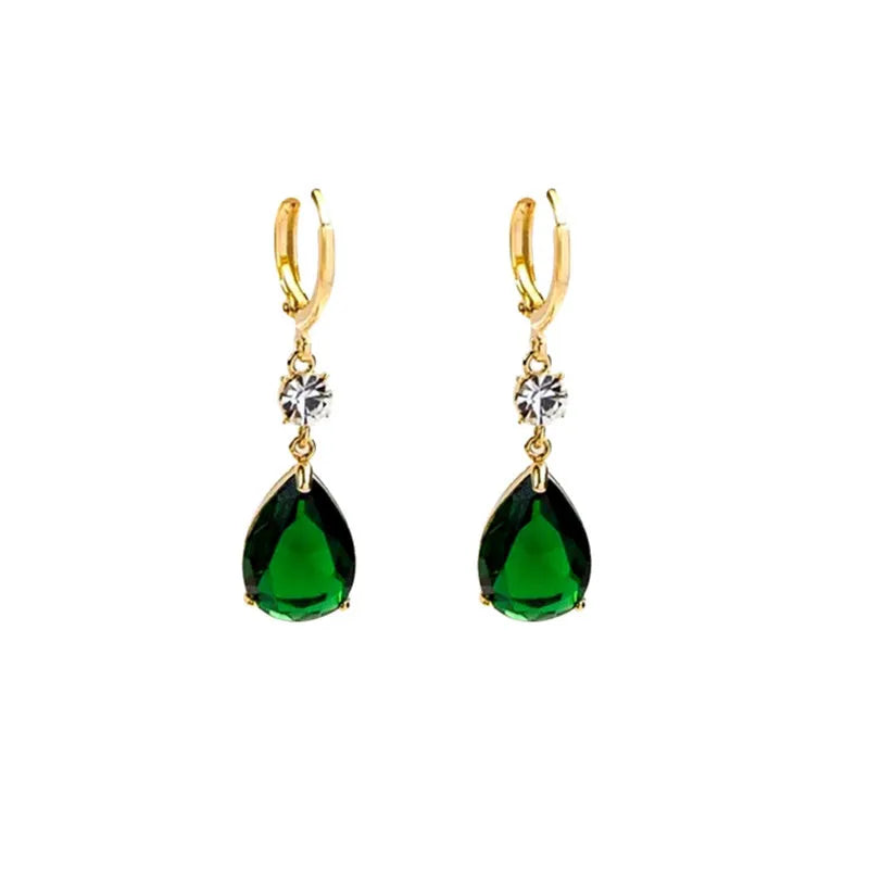 A pair of emerald green geometric teardrop alloy earrings on a plain background.