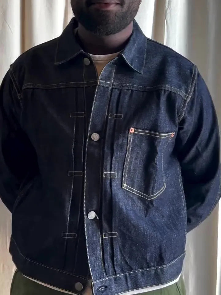 Dark blue denim button-up jacket with classic collar on a standard hanger