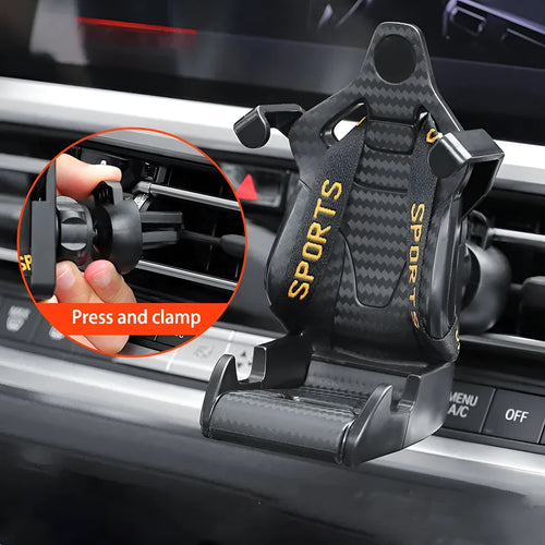 Gold coloured car air vent mobile phone holder with 360-degree rotating head mounted on a car dashboard vent.