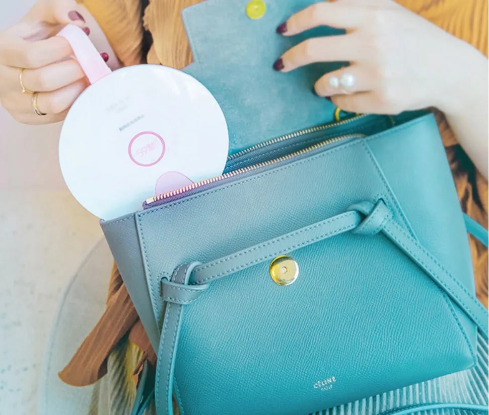Slim blue portable UV baby bottle steriliser with USB port shown next to a baby bottle.